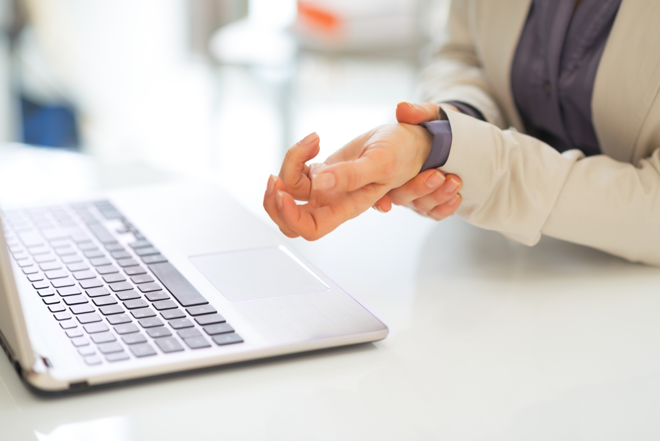 closeup on business woman with wrist pain